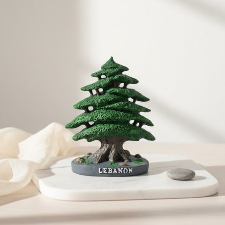 Textured moss green cedar ornament on a round grey base lettered Lebanon in white