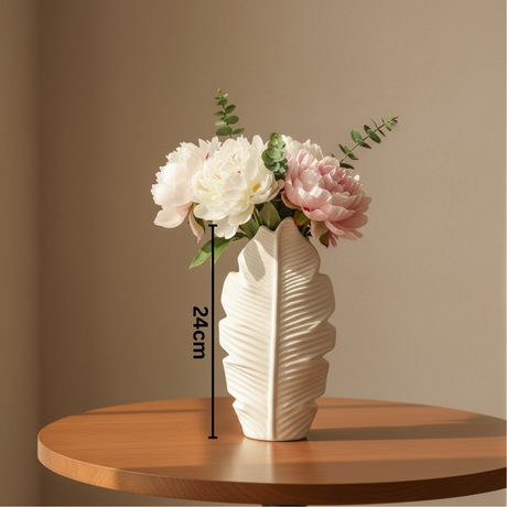 The smaller leaf vase on a round wooden table with peonies and eucalyptus, marked 24cm