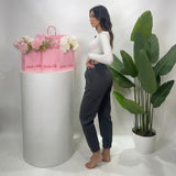 Side profile of charcoal sweatpants showing the relaxed seat and gathered ankle cuff