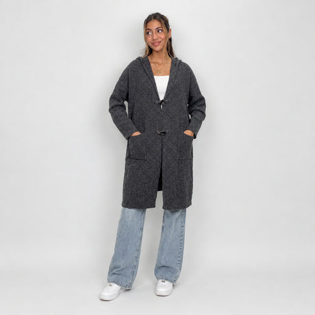 Charcoal hooded toggle cardigan worn open over a white crop top and jeans