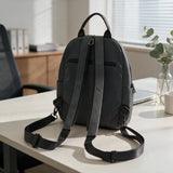 Back view of a charcoal mini backpack showing padded adjustable shoulder straps
