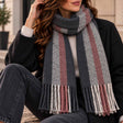 Charcoal, grey and dusty pink stripe scarf looped at the neck with twisted tassels