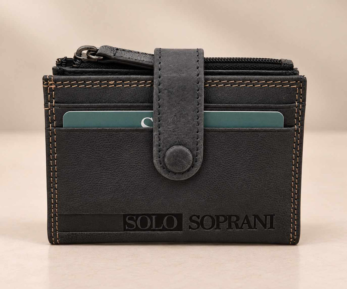 Closed slate grey compact wallet with a leather snap tab and top zip