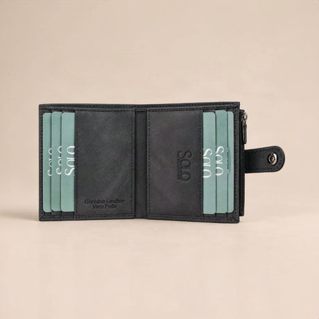 Charcoal nubuck interior lined with teal cards, the snap tab resting on the right edge