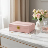 Light pink textured faux leather jewelry box closed with a gold flip clasp