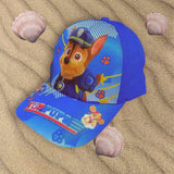 Royal blue police pup cap angled on sand, brim reading Top Pups