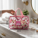Pink cosmetic cherry pouch with makeup items on a bathroom counter, showing dimensions 20x30cm