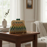 Handmade chevron clutch with a wooden frame and green clasp on a side table