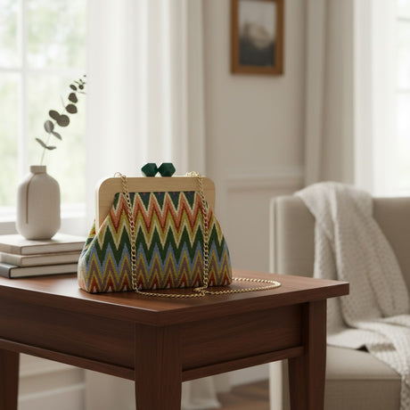 Handmade chevron clutch with a wooden frame and green clasp on a side table