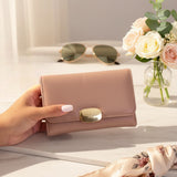 Close up of the gold clasp on the pink mini wallet
