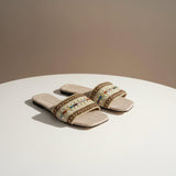 Pair of linen slides side by side, braided cord edging along a woven striped band
