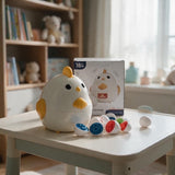 Chick egg puzzle toy beside its box with colourful number eggs on a white table