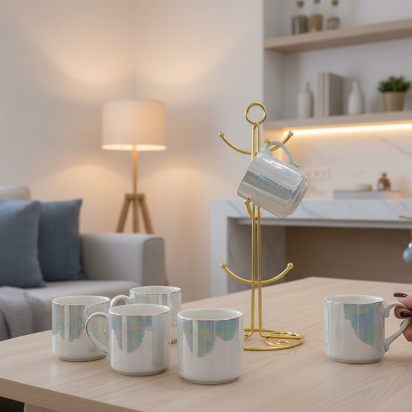 Hand lifting a white iridescent mug from a gold mug tree in a living room