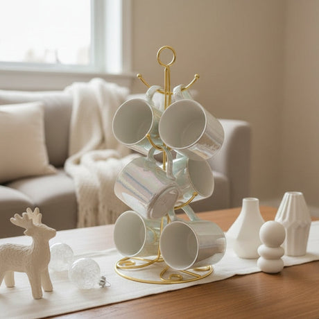White iridescent ceramic mugs hanging on a gold wire mug tree stand