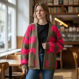 Fuchsia stripe cardigan paired with a black top in a cafe setting