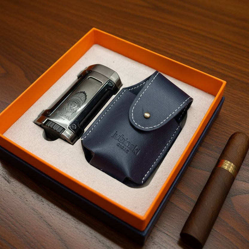 Cigar lighter and leather case in an open orange box on a wooden surface