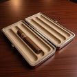 Open cigar case with a single cigar on a wooden surface