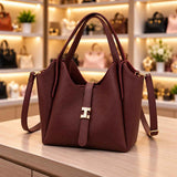 Burgundy pebbled bucket tote with a gold clasp strap, double handles and a long crossbody strap