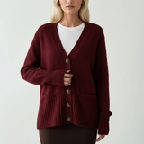 Red cardigan layered open, a white tee showing at the neck