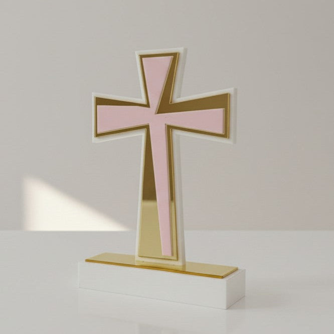 Flared acrylic cross in pale pink with a gold mirrored cross running down its shaft