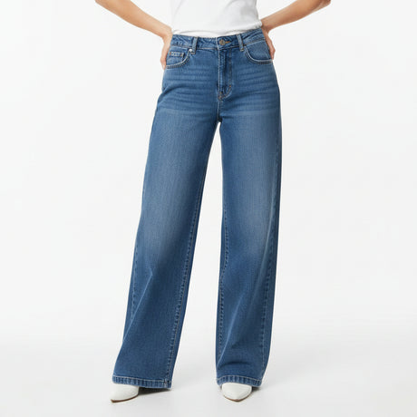 Blue jeans worn by a person on a white background