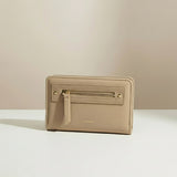 Beige wallet with gold zipper on a light beige background
