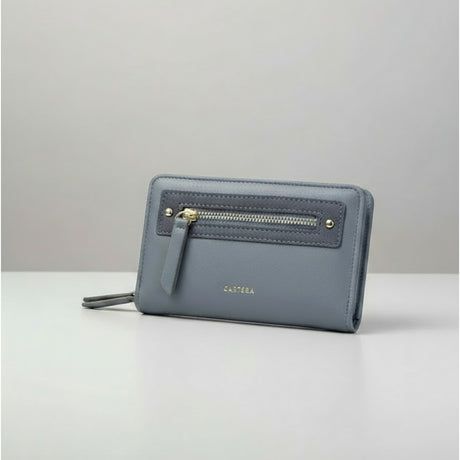 Blue women's wallet with zip pocket and gold details on a grey background