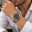 Fluted bezel steel watch with black dial worn with a white shirt