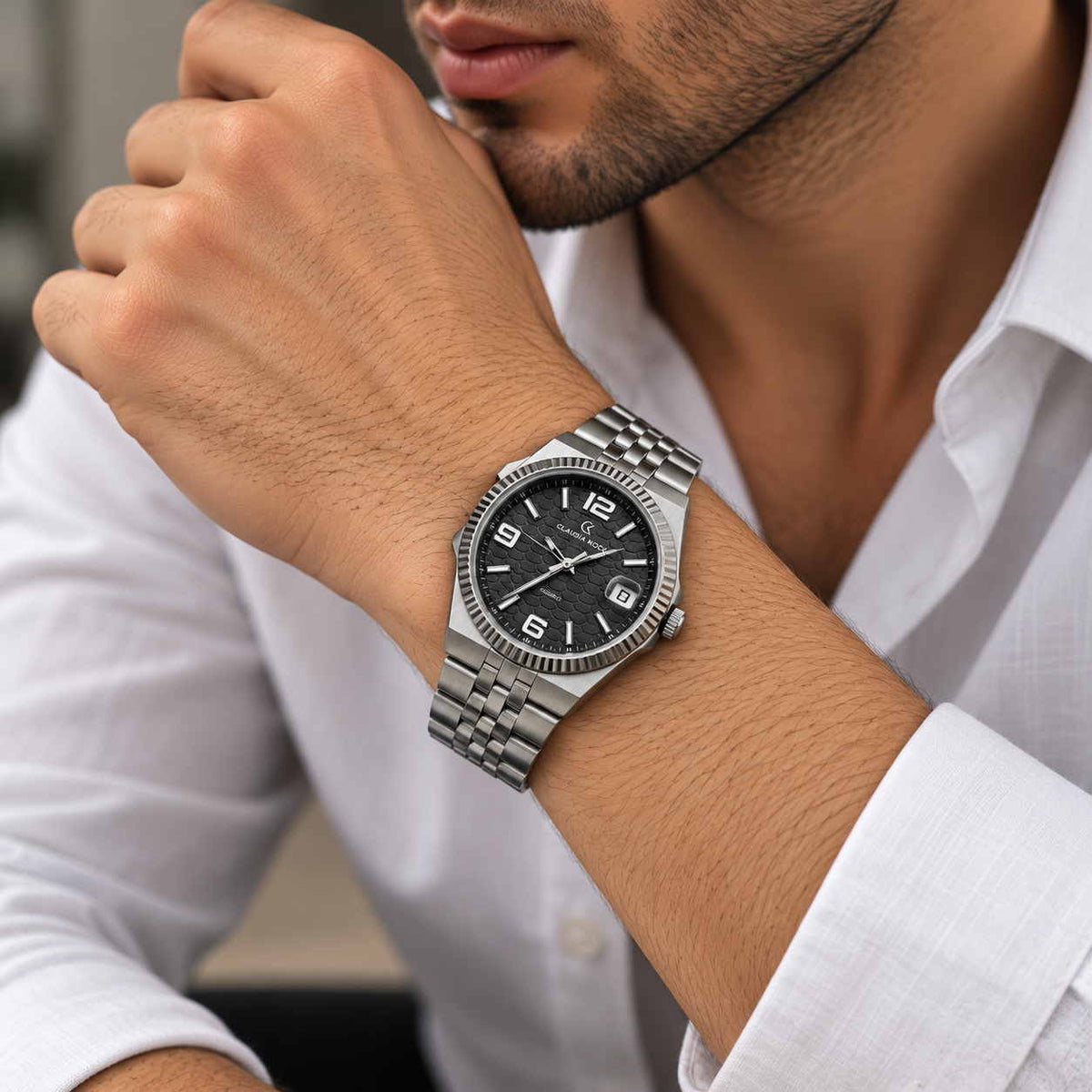 Fluted bezel steel watch with black dial worn with a white shirt