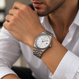 Fluted bezel steel watch with textured white dial and date window on the wrist