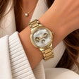 Gold multi dial watch with pearl face and three subdials worn on the wrist