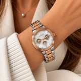 Rose gold and silver two tone multi dial watch worn with a pearl necklace