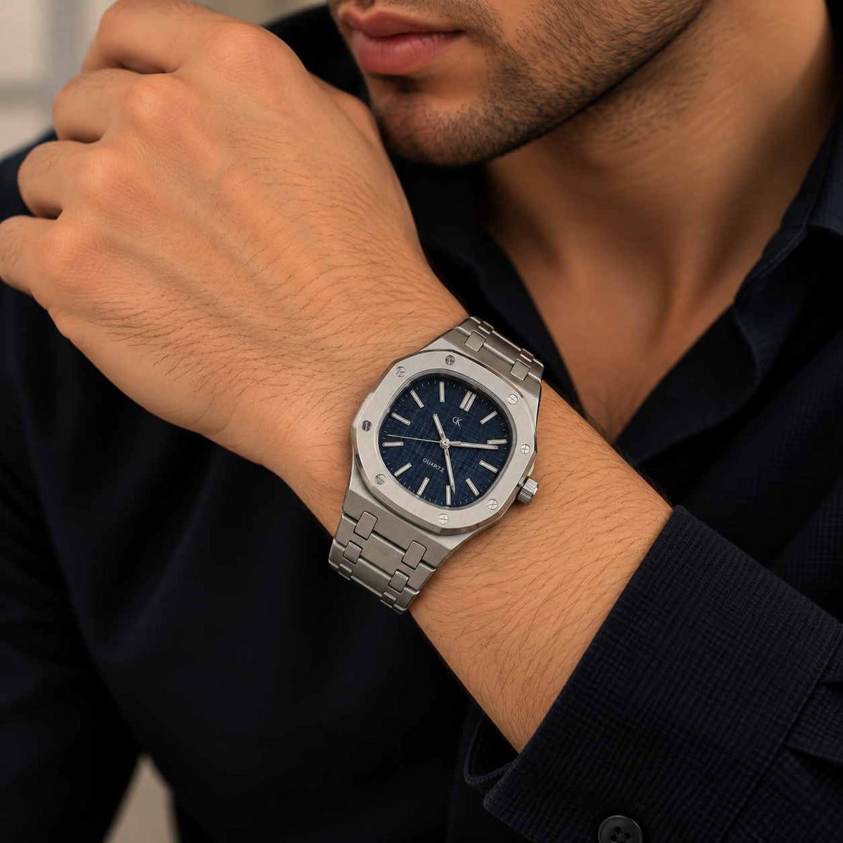 Navy dial steel watch with rounded octagon bezel worn with a black shirt