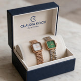 Rose gold and two tone green rectangle ladies watches in an open gift box