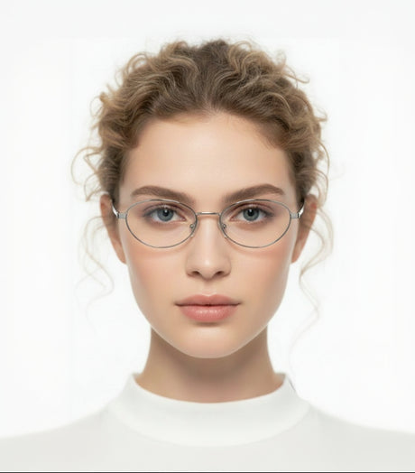 Woman wearing clear round sunglasses with a plain background