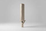 Foldable beige umbrella on a light grey background
