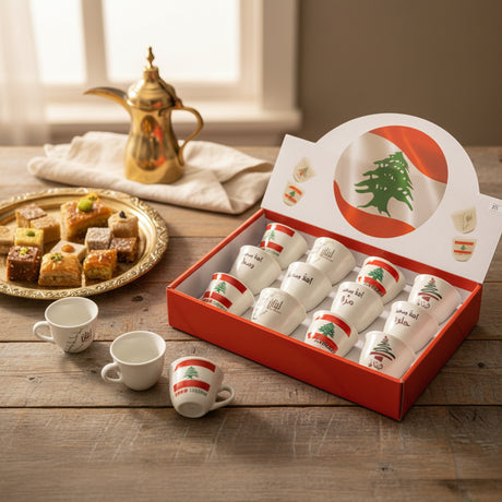 Red gift box of white porcelain espresso cups printed with the flag, a cedar and Arabic