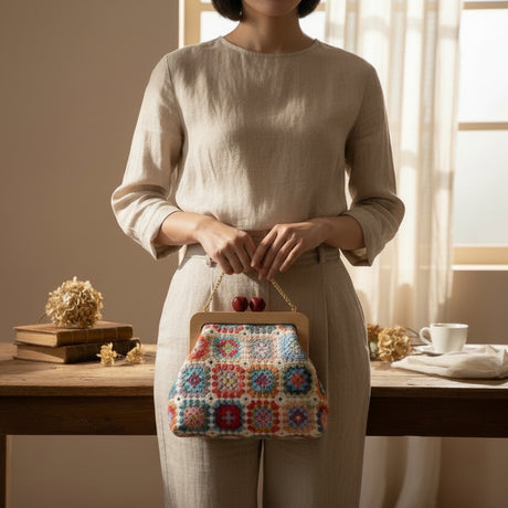 Side view of floral handmade bag showing crochet flower pattern and strap