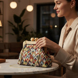 Woman at a cafe table resting her hand on the chevron frame bag