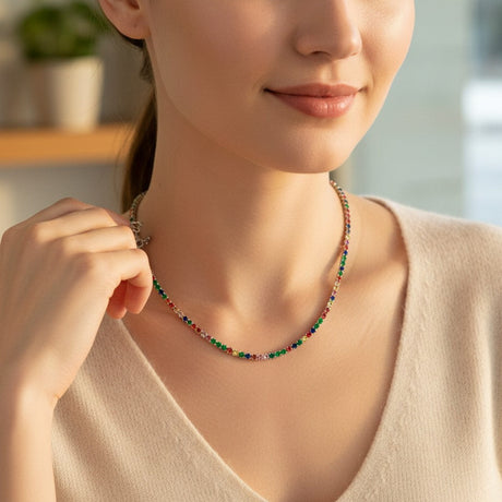 Woman wearing a colorful beaded tennis choker indoors with a blurred background