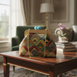 Kilim tribal frame bag in a living room setting, light blue gem clasp on top