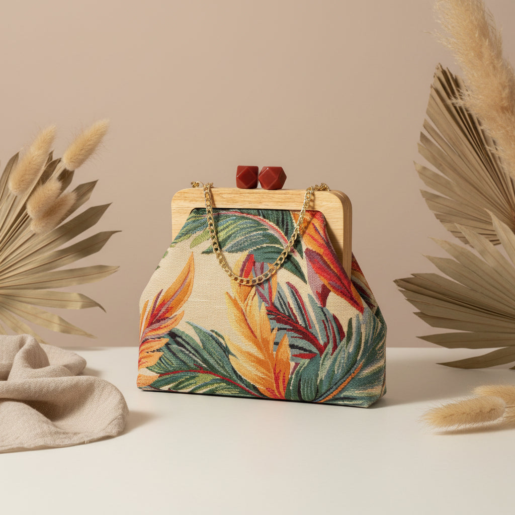 Cream tropical tapestry frame bag with green palm leaves and a coral clasp