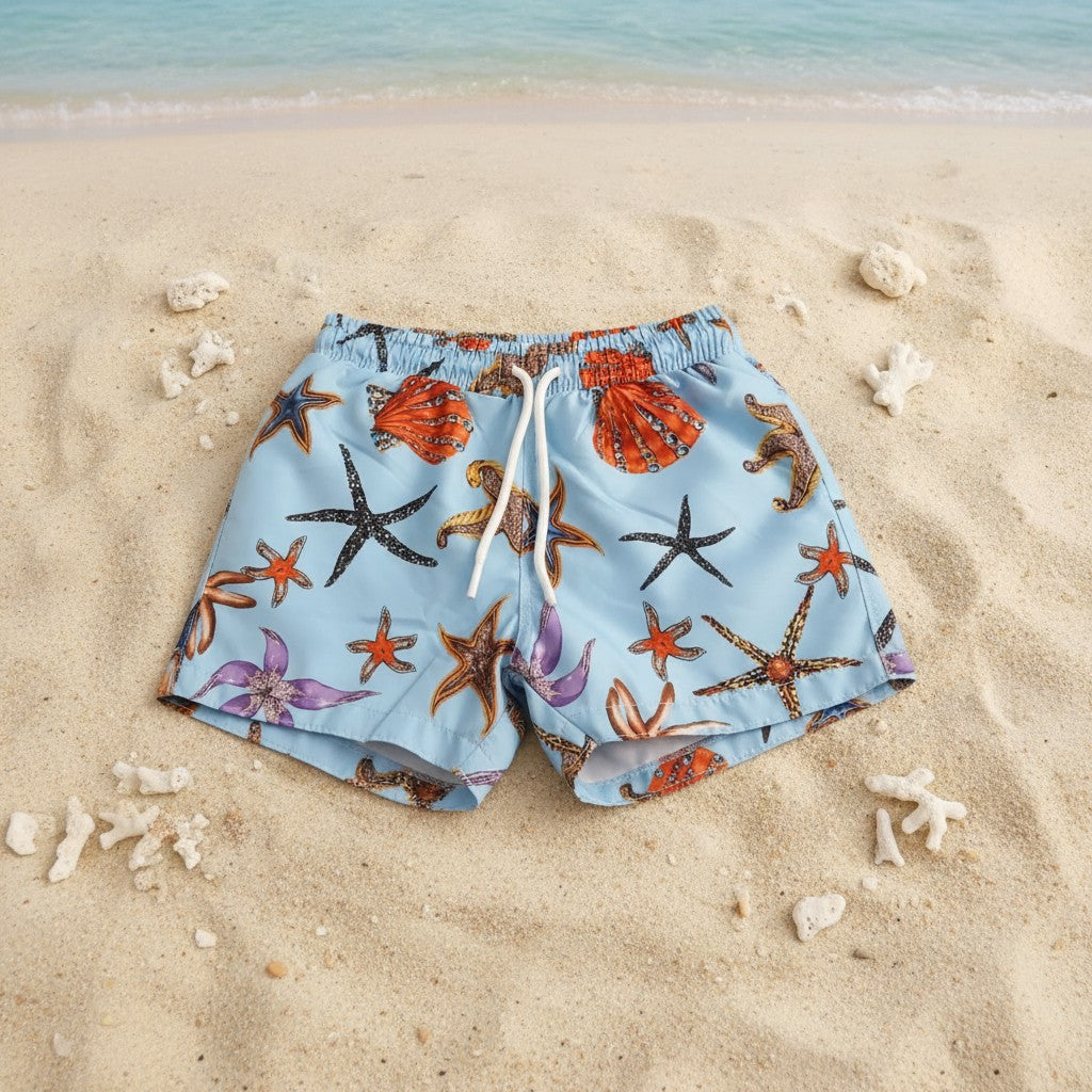 Light blue starfish and shell print boys swim shorts