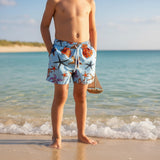 Boy wearing colourful starfish and shell print swim shorts on the beach – Jack Gifts Online Lebanon