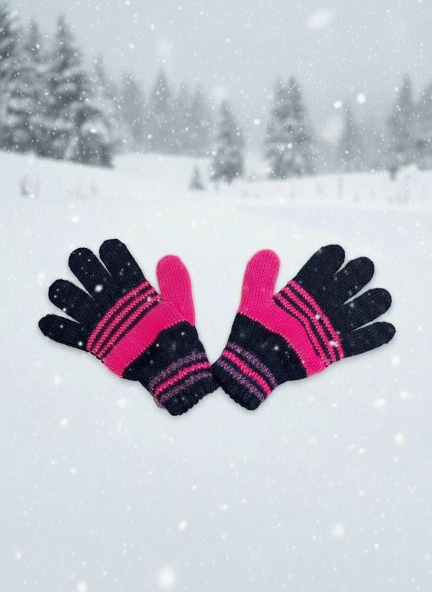 Black and hot pink striped kids gloves in a snowy forest