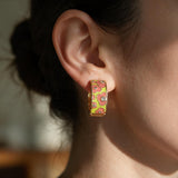 Coral and lime flower enamel huggie hoop earring with tiny crystals worn on the ear