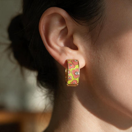 Coral and lime flower enamel huggie hoop earring with tiny crystals worn on the ear