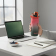 Slim tall water bottle in a coral to deep green ombre finish with a flip top lock lid