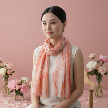 Woman wearing a pink coral scarf in a soft pink background