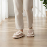 Rear view on a wooden floor showing the padded heel and horseshoe sherpa collar in pale pink